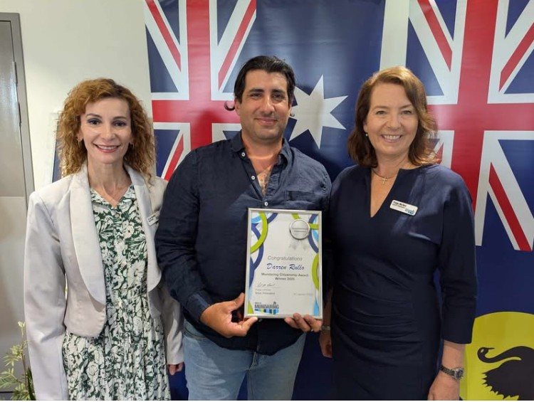 Darren Rullo holding his Inspirational Volunteer certificate