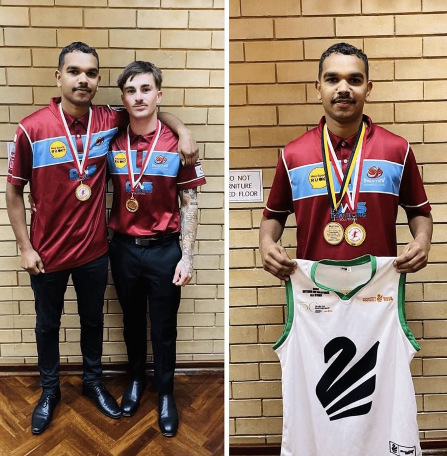 Two players in club polos holding their medals