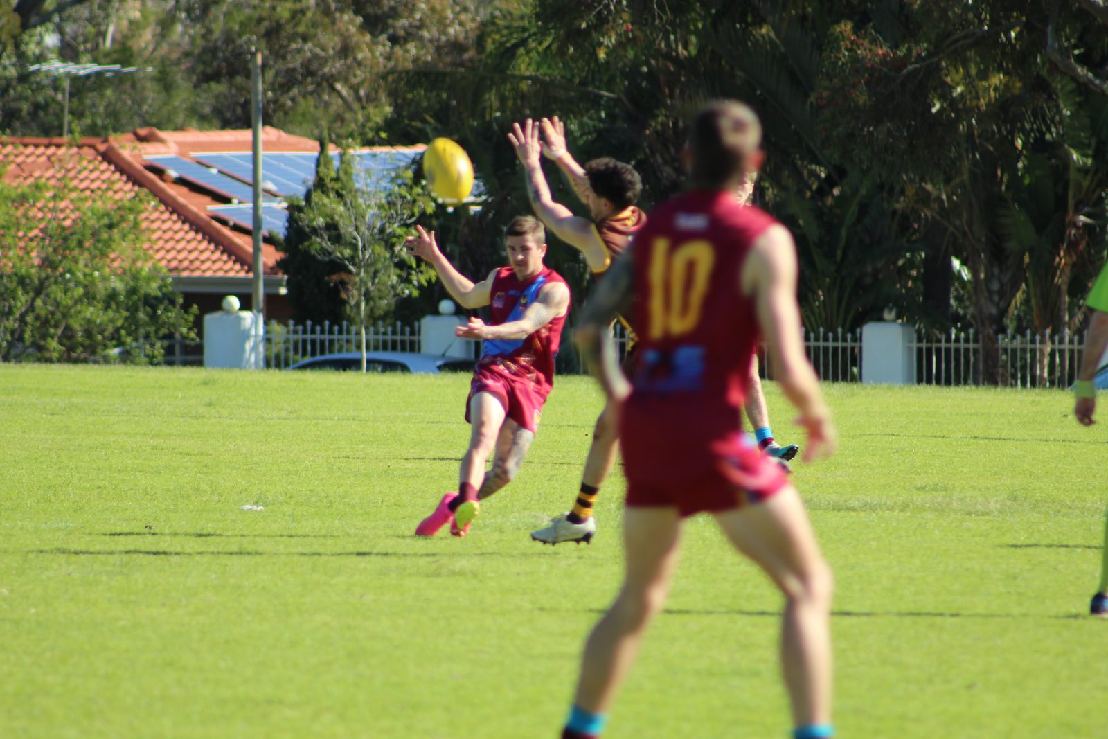 A Swan View senior player kicking the football