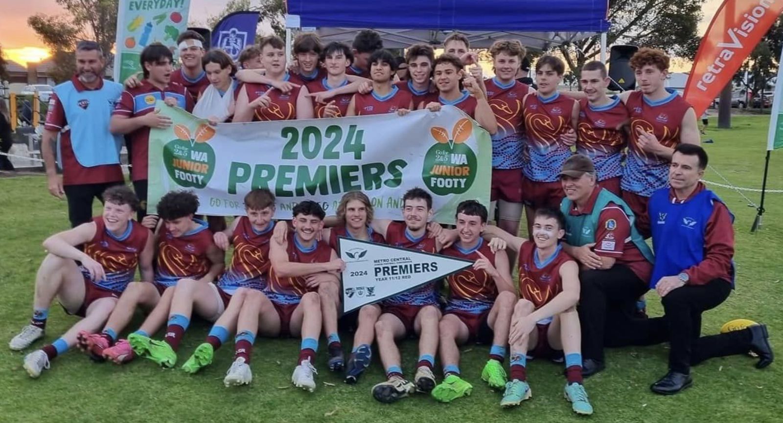 Year 11/12 team holding the 2024 Premiers banner